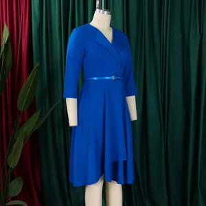 Close-up of an elegant royal blue V-neck dress with a high waist belt and a flowing skirt.