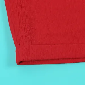 Macro view showing the intricate crinkled texture of the red fabric in this sexy set