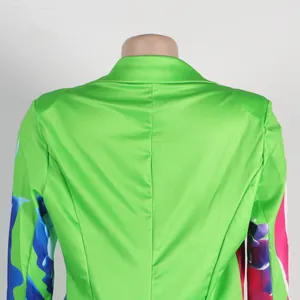 Close-up back detail of bright green blazer featuring vibrant floral sleeve prints