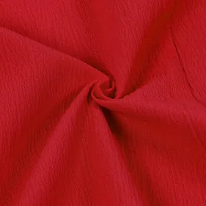 Close-up macro detail of soft red textured fabric showing its intricate crinkle pattern