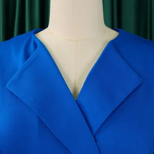 Close-up detail shot showing the elegant V-neckline and lapel on a royal blue dress