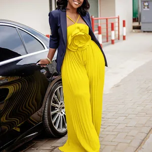 Stylish yellow pleated jumpsuit with a large 3D flower detail paired with a navy blazer