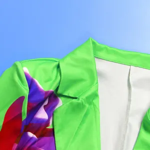 Detailed view of vibrant green blazer featuring large purple floral print and neat stitching