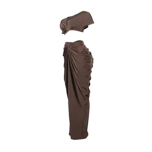 Detailed view of brown two-piece set featuring draped long skirt and crop top