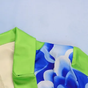 Detail view of a sexy floral print suit blazer featuring vibrant lime green lapel and blue pattern