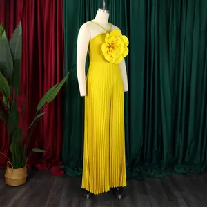 Fashionable yellow pleated jumpsuit with 3D flower detail on mannequin display.