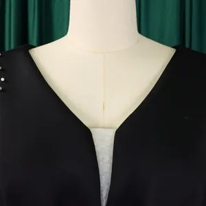 Detail view of a sexy V-neck evening dress with elegant beaded accents on the shoulder.