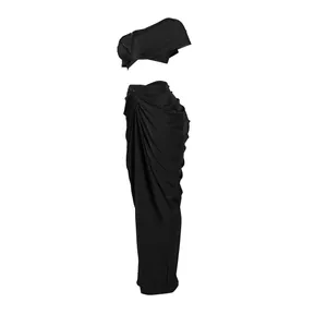 Detailed view of black two-piece outfit featuring draped maxi skirt and cropped top
