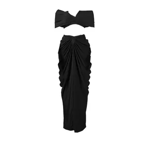 Front view of black two-piece set featuring strapless bandeau top and draped maxi skirt.