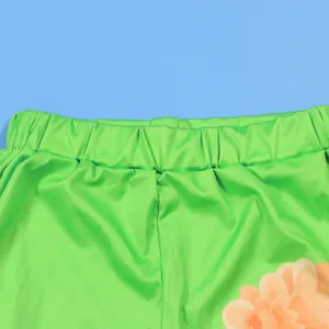Detailed macro view showing the elastic waistband of green floral printed shorts