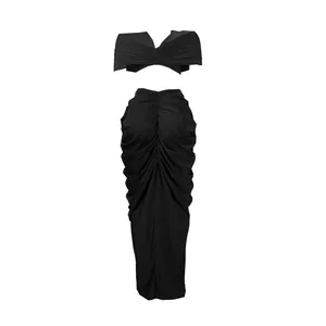 Detailed view of the black ruched two-piece set with off-shoulder top and maxi skirt