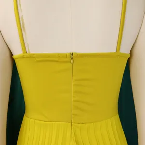Macro view of the back zipper and pleated fabric detail on this yellow jumpsuit
