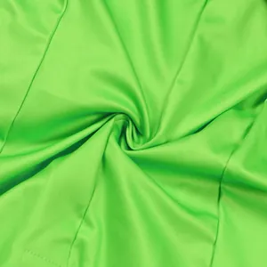 Detailed macro view showing the vibrant lime green fabric texture of this shorts suit.