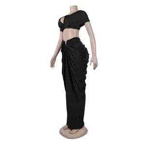 Side view of elegant black two-piece set featuring sleeveless top and pleated maxi skirt