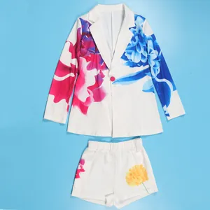 Stylish white blazer and shorts set featuring vibrant pink and blue floral prints