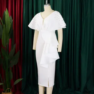 Detail of white V-neck evening dress with ruffle layer and pearl beaded shoulders