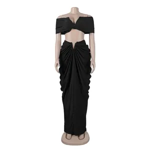 Detail view of black two-piece off-the-shoulder crop top and draped maxi skirt set.