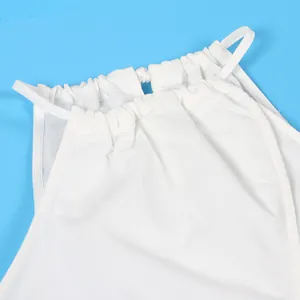 Close-up of white halter top neckline showing textured fabric and drawstring detail