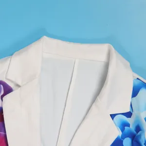 Close-up detail of white blazer collar with blue and purple floral prints.