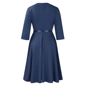 Back view of a navy blue long-sleeved A-line dress featuring a high waist and belt.