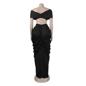 Back view of elegant black two-piece set featuring off-the-shoulder top and ruched maxi skirt.