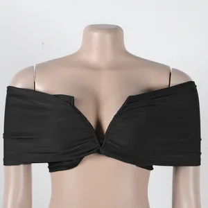 Detailed view of the black pleated off-the-shoulder crop top with elastic fabric texture
