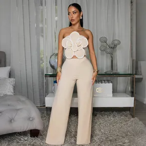 Détail chic d'un ensemble beige deux pièces avec bustier fleur 3D et pantalon large