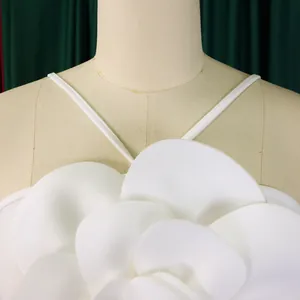 Close-up of the large 3D white floral decoration on the bodice of the jumpsuit