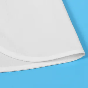 Detailed macro view showing white fabric texture and curved split hem stitching of garment