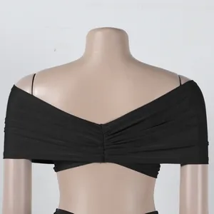 Detailed back view of an elegant black pleated off-shoulder top with ruched texture