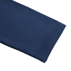 Close-up of navy blue ribbed fabric with precise double-needle stitching detail.