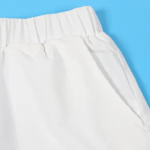 Detail of white crinkled fabric shorts with elastic waistband and side pocket