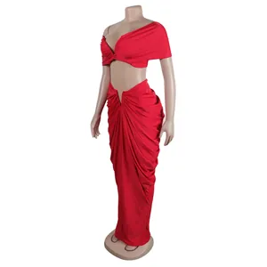 Red sexy two-piece set featuring strapless wrap top and long pleated skirt on mannequin