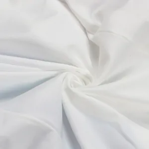 Close-up macro view of high-quality soft white fabric texture with elegant spiral folds