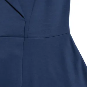 Macro shot of the tailored high waist and V-neck of a solid navy blue dress.