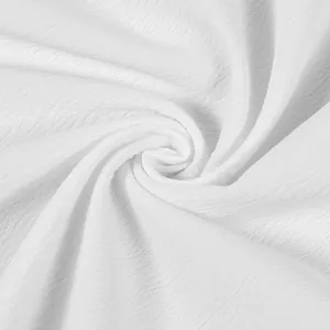 Close-up macro view of premium white textured fabric with an elegant spiral ripple pattern detail