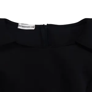 Close-up view of black elegant banquet dress neckline featuring brand label and zipper.