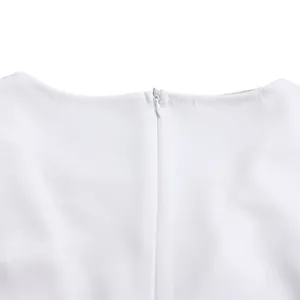 Close-up detail of the hidden back zipper on a white elegant wide-leg fashion jumpsuit