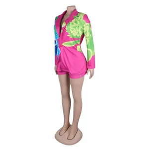 Detailed side view of a vibrant pink floral blazer and shorts set on mannequin