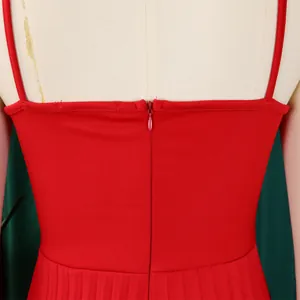Close-up of back zipper and thin straps on a vibrant red pleated jumpsuit garment