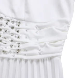 Close-up detail of white jumpsuit waist decorated with delicate beads and rhinestones