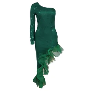 Detail of emerald green one-shoulder sequin dress with asymmetrical tulle ruffle hem.