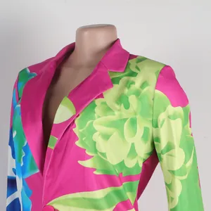 Close-up detail view of vibrant pink and green floral print blazer with notched lapel