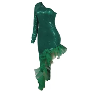 Detailed shot of emerald green one-shoulder sequin dress with irregular mesh ruffled hem