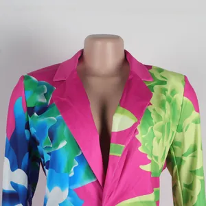 Detailed view of a vibrant floral print women's blazer featuring bright pink lapels