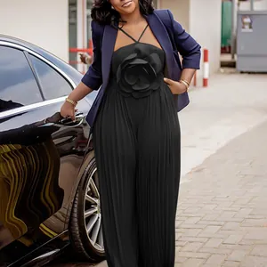 Elegant black pleated jumpsuit with 3D flower detail and navy blazer for stylish women