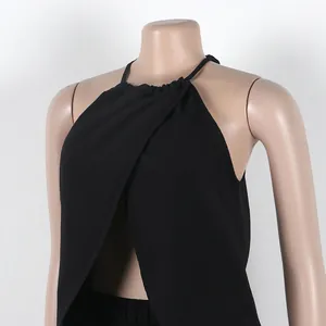 Close-up of black solid color halter wrap top with cross-front design on mannequin