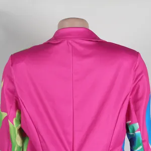 Detail of the back view of a vibrant pink floral blazer with structured shoulders.