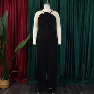 Elegant black pleated jumpsuit featuring a prominent 3D fabric flower detail on the chest.