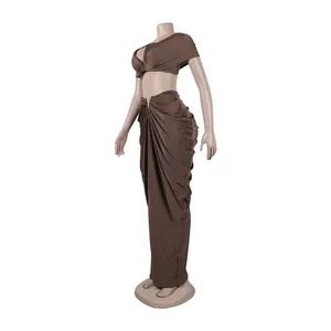 Detailed view of brown two-piece set featuring a pleated maxi skirt and crop top